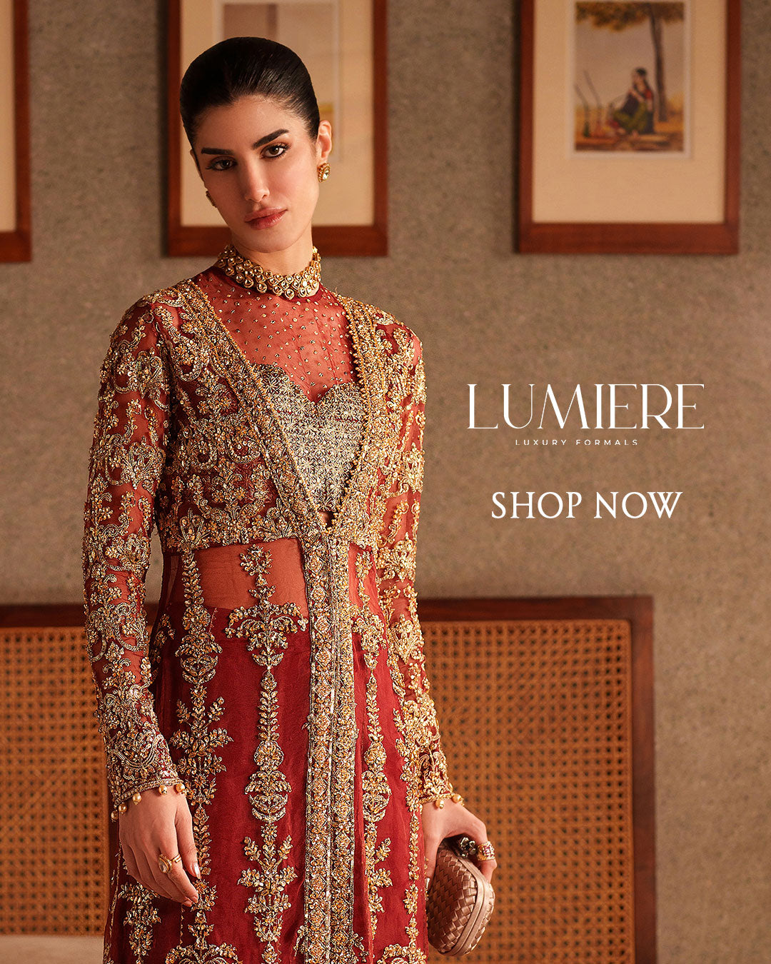 Rust red formal dress with intricate gold embroidery, sheer neckline panel, and fitted long sleeves